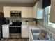 Modern kitchen featuring white cabinets, stainless steel appliances, and sleek countertops at 990 Sunchaser Rd, Lebanon, IN 46052