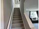 Carpeted staircase leading to an upper level with living room view at 990 Sunchaser Rd, Lebanon, IN 46052