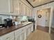 Functional kitchen with white cabinets, updated appliances, and a view to the hallway at 107 Knoll Ct # F, Noblesville, IN 46062