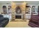 Cozy living room with a stone fireplace, built-in bookshelves, and ample natural light, creating a relaxing atmosphere at 107 Knoll Ct # F, Noblesville, IN 46062