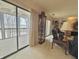 Bright living room with sliding glass doors to a balcony, a display cabinet, and comfortable seating at 107 Knoll Ct # F, Noblesville, IN 46062