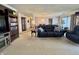 Spacious living room with a comfortable sofa, a display cabinet, and views to the dining room at 107 Knoll Ct # F, Noblesville, IN 46062