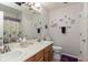 Bright bathroom with dual sinks, white cabinets, and decorative mirrors, perfect for a shared space at 10820 Washington Bay Dr, Fishers, IN 46037