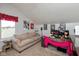 Cozy bedroom with a comfortable couch and a workspace with multiple monitors and charming decor at 10820 Washington Bay Dr, Fishers, IN 46037