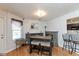 Stylish dining area featuring hardwood floors, natural light, and functional bar area for entertaining at 10820 Washington Bay Dr, Fishers, IN 46037