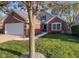 A lovely brick home with a well-kept lawn and a two-car garage at 10820 Washington Bay Dr, Fishers, IN 46037