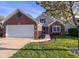 A brick home with a well-kept lawn and a two-car attached garage at 10820 Washington Bay Dr, Fishers, IN 46037