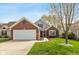 Charming brick home with a manicured lawn and two-car garage, creating excellent curb appeal at 10820 Washington Bay Dr, Fishers, IN 46037