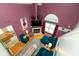 Bright living room boasts high ceilings, a fireplace, and stylish plum-colored walls at 10820 Washington Bay Dr, Fishers, IN 46037