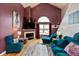 Bright living room boasts high ceilings, a fireplace, and stylish plum-colored walls at 10820 Washington Bay Dr, Fishers, IN 46037