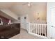 Upstairs hallway featuring a chandelier, natural lighting, and white railing at 10820 Washington Bay Dr, Fishers, IN 46037