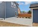 Backyard view with tidy landscaping and a fence between the garage and the home at 1158 Burdsal Pkwy, Indianapolis, IN 46208
