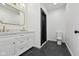 Stylish bathroom featuring a double vanity, black framed shower and modern toilet at 1158 Burdsal Pkwy, Indianapolis, IN 46208