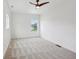 Bright bedroom boasts three windows, neutral carpet, and recessed lighting at 1158 Burdsal Pkwy, Indianapolis, IN 46208