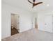 Bright bedroom features a ceiling fan, neutral carpet, and an ensuite bathroom at 1158 Burdsal Pkwy, Indianapolis, IN 46208