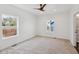 Bright bedroom with two windows, neutral carpet, and a ceiling fan at 1158 Burdsal Pkwy, Indianapolis, IN 46208