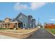 Charming two-story blue home featuring a landscaped front yard and private driveway, all under a sunny blue sky at 1158 Burdsal Pkwy, Indianapolis, IN 46208