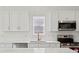 Bright kitchen with stainless appliances, gold fixtures, and white countertops at 1158 Burdsal Pkwy, Indianapolis, IN 46208