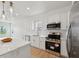 Clean, bright kitchen with an island, stainless steel appliances and gold fixtures at 1158 Burdsal Pkwy, Indianapolis, IN 46208
