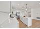 Modern kitchen with an island, stainless steel appliances, and white countertops at 1158 Burdsal Pkwy, Indianapolis, IN 46208