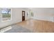 Bright living room with luxury vinyl plank floors, a stained glass front door, and natural light from multiple windows at 1158 Burdsal Pkwy, Indianapolis, IN 46208
