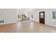 Bright living room with luxury vinyl plank floors, stylish decor, natural light from multiple windows, and a stained-glass front door at 1158 Burdsal Pkwy, Indianapolis, IN 46208