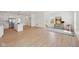 Bright, open-concept living space featuring a modern kitchen and island, adjacent to a small seating area with natural light at 1158 Burdsal Pkwy, Indianapolis, IN 46208