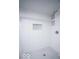Bright white bathroom featuring tiled shower with built-in niche and white shower curtain at 117 W Arizona St, Indianapolis, IN 46225