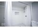 Bright white bathroom featuring tiled shower with built-in niche and white shower curtain at 117 W Arizona St, Indianapolis, IN 46225