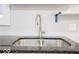 A close-up of a stainless steel sink with a granite countertop, creating a modern look and functional space at 117 W Arizona St, Indianapolis, IN 46225