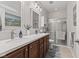 This is a full bathroom with a double vanity and granite countertops, tiled floors, and a sliding door shower at 12821 Gloria Dr, Fishers, IN 46037