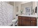 Cozy bathroom with tile flooring, shower with leaf-patterned curtain, and dark vanity at 12821 Gloria Dr, Fishers, IN 46037