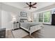 This is a bedroom with beautiful natural light and hardwood floors with a bed that has white trim and neutral bedding at 12821 Gloria Dr, Fishers, IN 46037