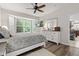Light filled bedroom features neutral colors, hardwood floors, comfortable bedding, large windows and is adjacent to the kitchen at 12821 Gloria Dr, Fishers, IN 46037