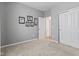 Neutral bedroom featuring carpeted floor, closet, with gray walls and white doors and trim at 12821 Gloria Dr, Fishers, IN 46037