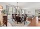 Elegant dining room with a wooden table, six chairs, and plenty of natural light at 12821 Gloria Dr, Fishers, IN 46037