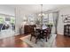 Formal dining area with a large table, chandelier, and hardwood flooring at 12821 Gloria Dr, Fishers, IN 46037