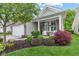 Landscaped front yard with lush greenery and flowering bushes, leading to a charming home at 12821 Gloria Dr, Fishers, IN 46037