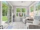 Bright sunroom with comfortable seating, multiple windows, and sliding glass door at 12821 Gloria Dr, Fishers, IN 46037