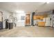 Functional basement laundry area with washer, dryer, utility sink, storage cabinets, and access to the garage at 1507 Lynnwood Dr, Anderson, IN 46012