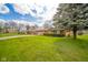 Quaint home with brick exterior, a well-manicured front lawn, a long driveway, and mature trees at 1507 Lynnwood Dr, Anderson, IN 46012