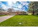 Charming single-story home with a well-maintained lawn and inviting curb appeal with mature trees at 1507 Lynnwood Dr, Anderson, IN 46012