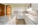 Modern kitchen with white cabinets, tile backsplash, and stainless steel appliances at 1507 Lynnwood Dr, Anderson, IN 46012