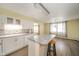 Open kitchen layout featuring white cabinets, a center island, and wood-look flooring at 1507 Lynnwood Dr, Anderson, IN 46012