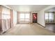 Inviting living room with a large window, neutral carpet, and ample natural light at 1507 Lynnwood Dr, Anderson, IN 46012