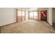 Bright living room featuring a large window, neutral carpet, and a front door at 1507 Lynnwood Dr, Anderson, IN 46012