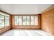 Bright sunroom with brick accent wall, tile floors, and lots of windows bringing in natural light and outdoor views at 1507 Lynnwood Dr, Anderson, IN 46012