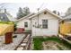 Wide shot of back of house. Backyard featuring fence, grass and gravel at 1510 Asbury St, Indianapolis, IN 46203