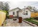 Backyard of house, featuring fence, small patio and gravel section with metal fire pit at 1510 Asbury St, Indianapolis, IN 46203