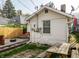 The back of a home, with a lawnmower, a picnic table and a barrel sitting on stone at 1510 Asbury St, Indianapolis, IN 46203